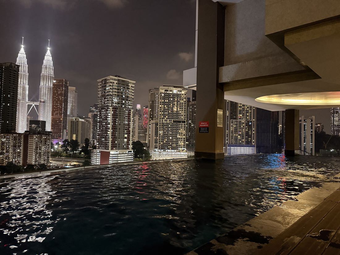 The Petronas Twin Towers lit at dusk over the Kuala Lumpur skyline