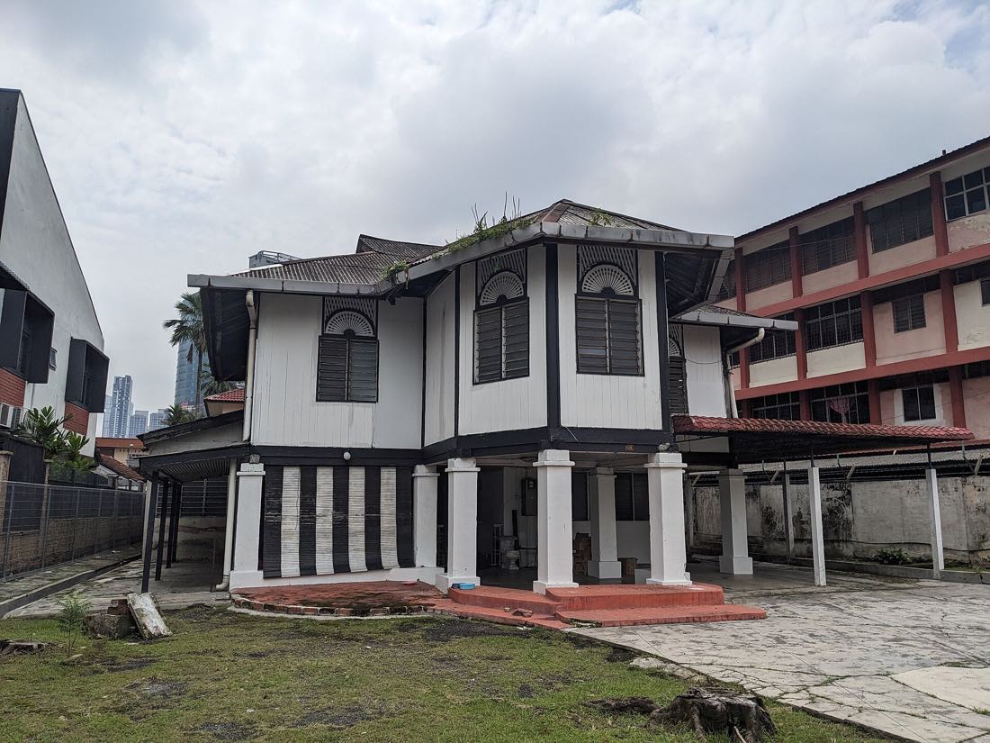 A traditional Malay house in Kampung Baru under the Kuala Lumpur skyline